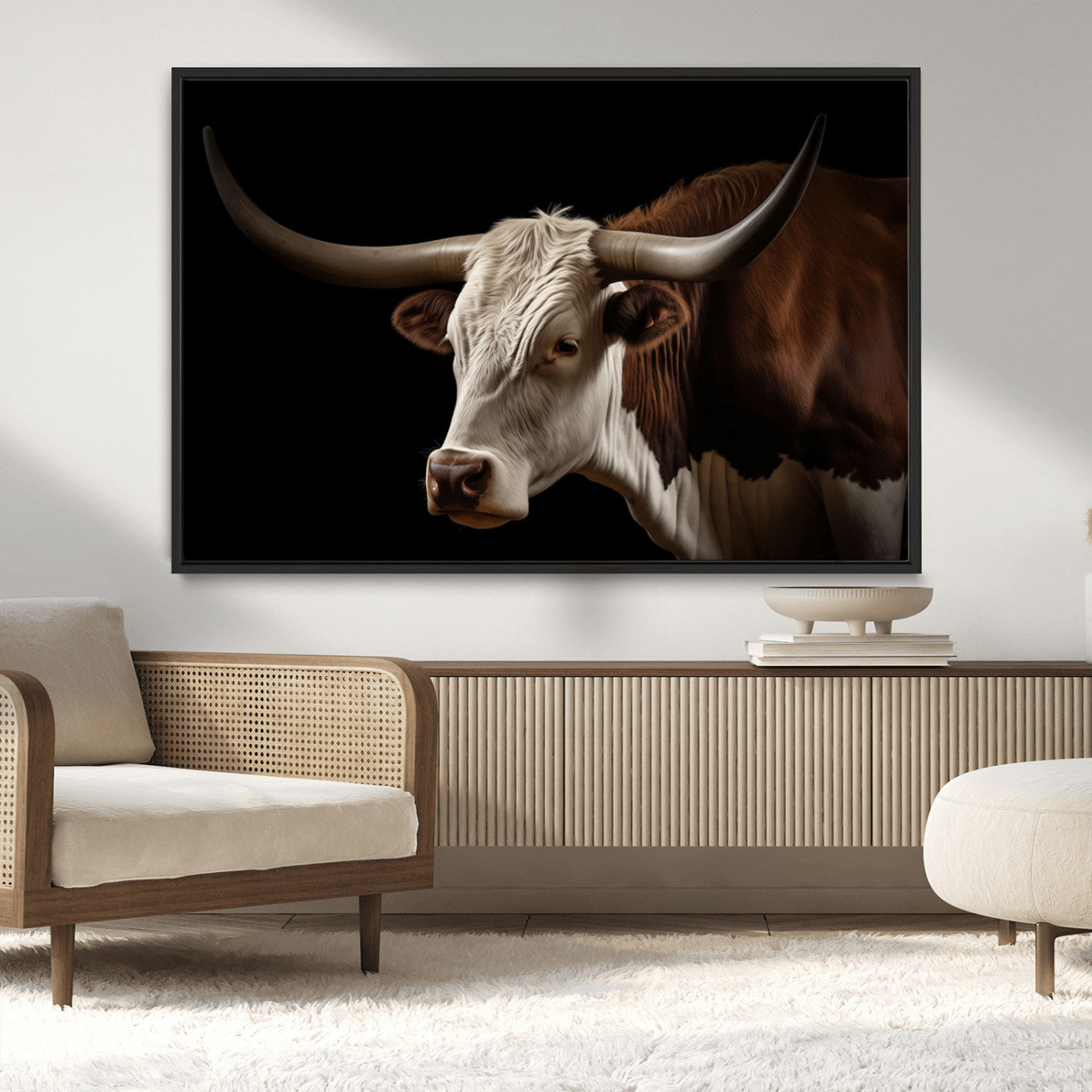 "Close-up of a brown and white longhorn cow with prominent curved horns against a black background."