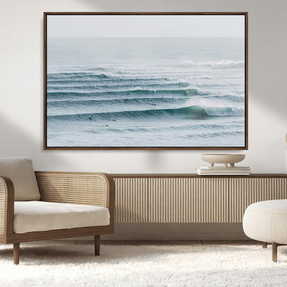 High-angle view of surfers lining up across layered ocean waves, ideal for minimal coastal or surf-inspired room decor.