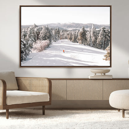 Bright ski trail lined with snow-covered pines and a skier in orange, perfect for alpine adventure or winter sports-inspired decor.