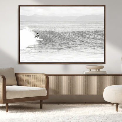 Monochrome photo of a surfer riding a wave with distant mountains, ideal for coastal motion or black and white surf-themed wall decor.