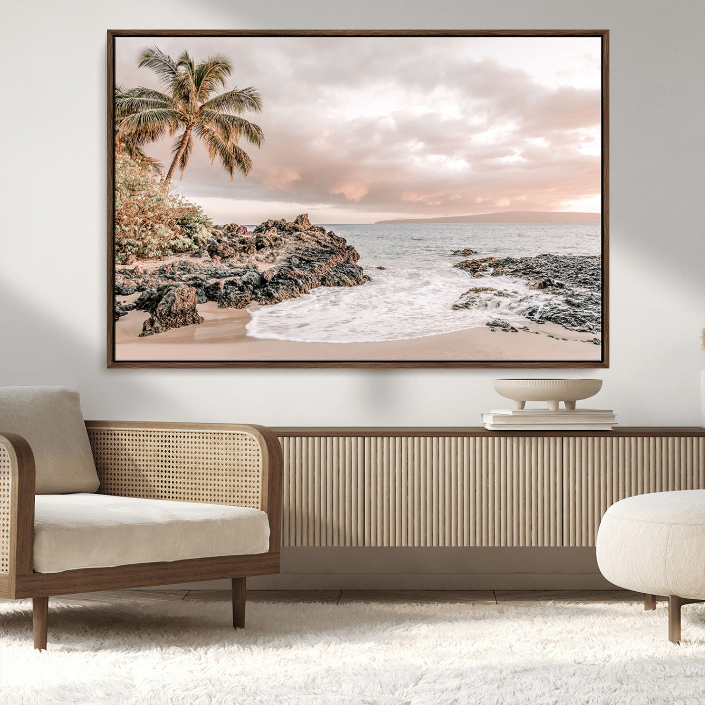 A peaceful beach scene with a palm tree and rocks, soft waves washing onto the shore under a soft pastel sky at sunset.