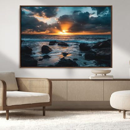 An awe-inspiring sunset over the ocean with rays of light piercing through dramatic clouds, creating a beautiful seascape with rocks in the foreground.