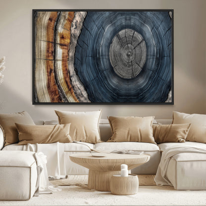 A stunning close-up of a tree trunk showing the intricate, circular growth rings, showcasing the natural textures and rich contrasts in deep blues, browns, and silvers.