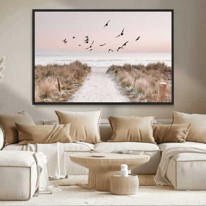 A peaceful coastal pathway leading to the ocean, with birds flying across a soft pastel sky, creating a calm and scenic beach atmosphere.