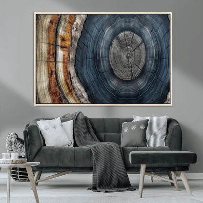 A stunning close-up of a tree trunk showing the intricate, circular growth rings, showcasing the natural textures and rich contrasts in deep blues, browns, and silvers.