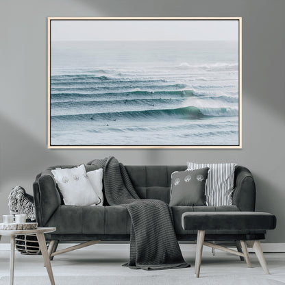 High-angle view of surfers lining up across layered ocean waves, ideal for minimal coastal or surf-inspired room decor.