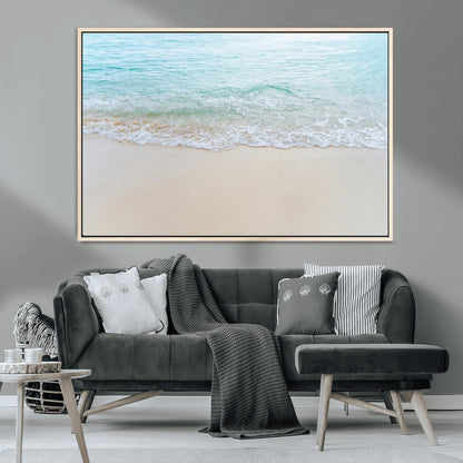 Soft shoreline with gentle aqua waves on smooth sand, ideal for minimalist coastal or pastel ocean-inspired home wall decor.
