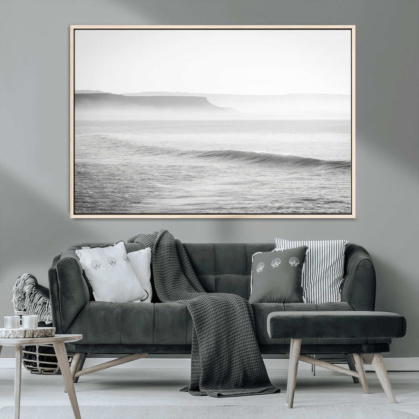 A black and white minimalist seascape featuring soft rolling waves and misty distant cliffs, creating a serene and timeless coastal atmosphere.