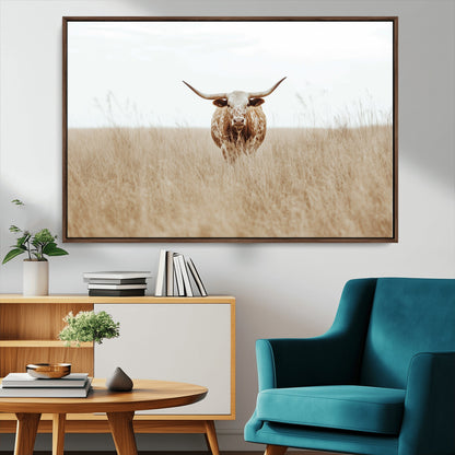 Texas Longhorn bull standing alone in dry grass with neutral tones, ideal for rustic western or cowboy-themed wall decor.