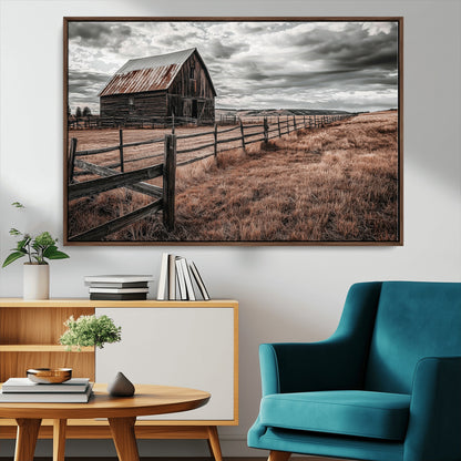 Framed canvas of a rustic barn under a moody sky with weathered fence and dark fields, ideal for farmhouse or rural-style wall decor.