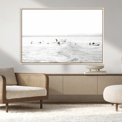 Monochrome photo of surfers riding and waiting on ocean waves, ideal for surf-themed or coastal energy wall decor.