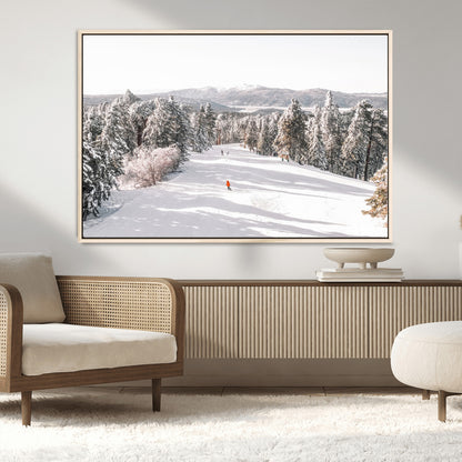 Bright ski trail lined with snow-covered pines and a skier in orange, perfect for alpine adventure or winter sports-inspired decor.