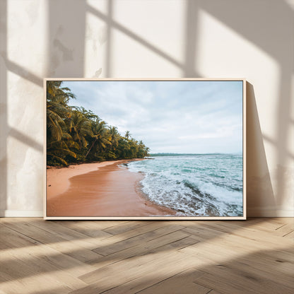Framed canvas of a tropical beach with palm trees and soft waves, ideal for coastal escape or serene nature-inspired home decor.