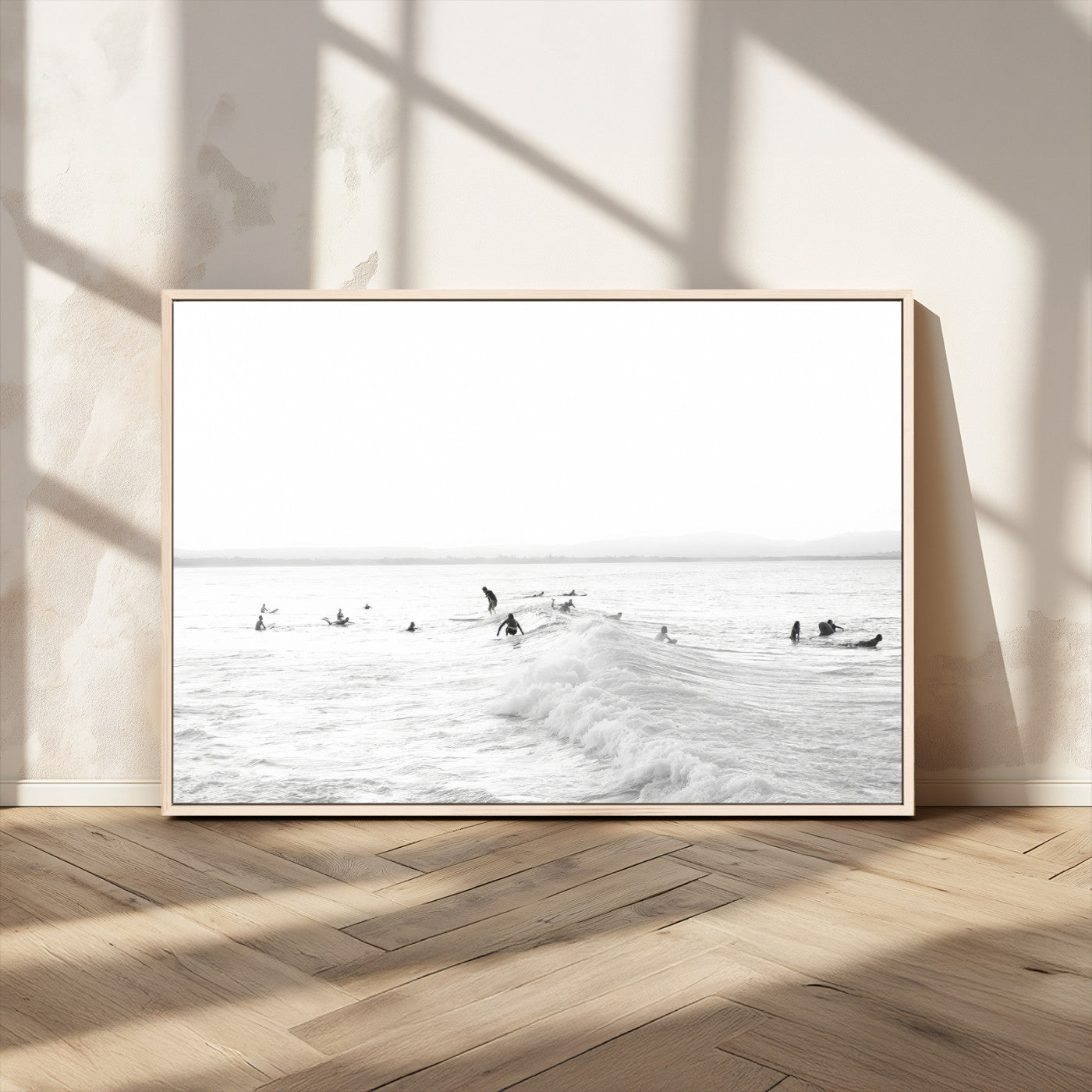 Monochrome photo of surfers riding and waiting on ocean waves, ideal for surf-themed or coastal energy wall decor.