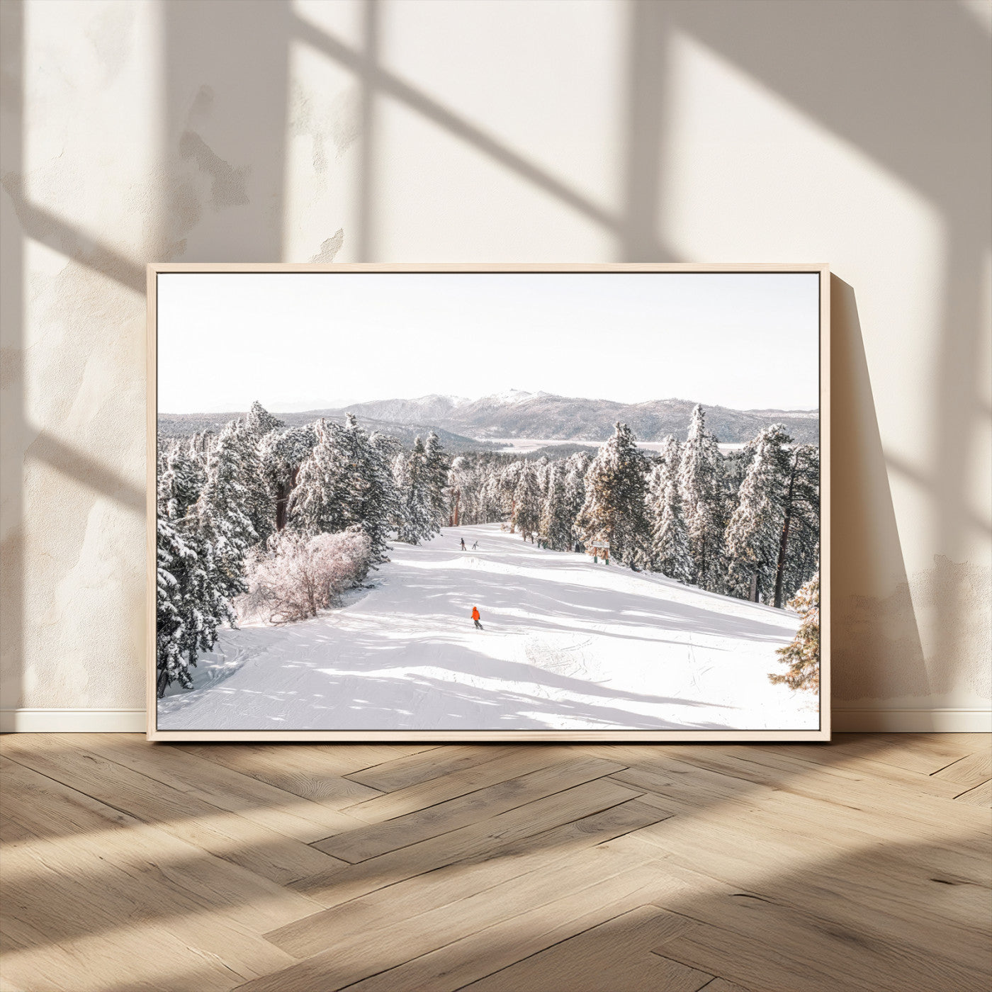 Bright ski trail lined with snow-covered pines and a skier in orange, perfect for alpine adventure or winter sports-inspired decor.