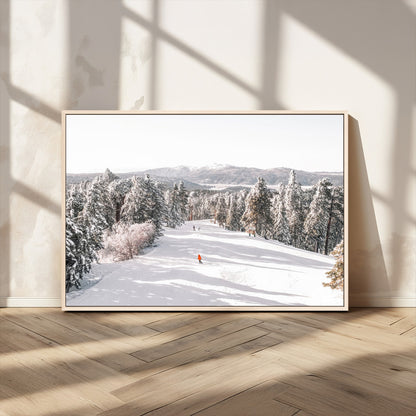 Bright ski trail lined with snow-covered pines and a skier in orange, perfect for alpine adventure or winter sports-inspired decor.