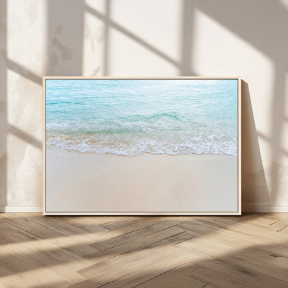 Soft shoreline with gentle aqua waves on smooth sand, ideal for minimalist coastal or pastel ocean-inspired home wall decor.
