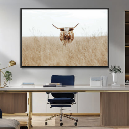 Texas Longhorn bull standing alone in dry grass with neutral tones, ideal for rustic western or cowboy-themed wall decor.