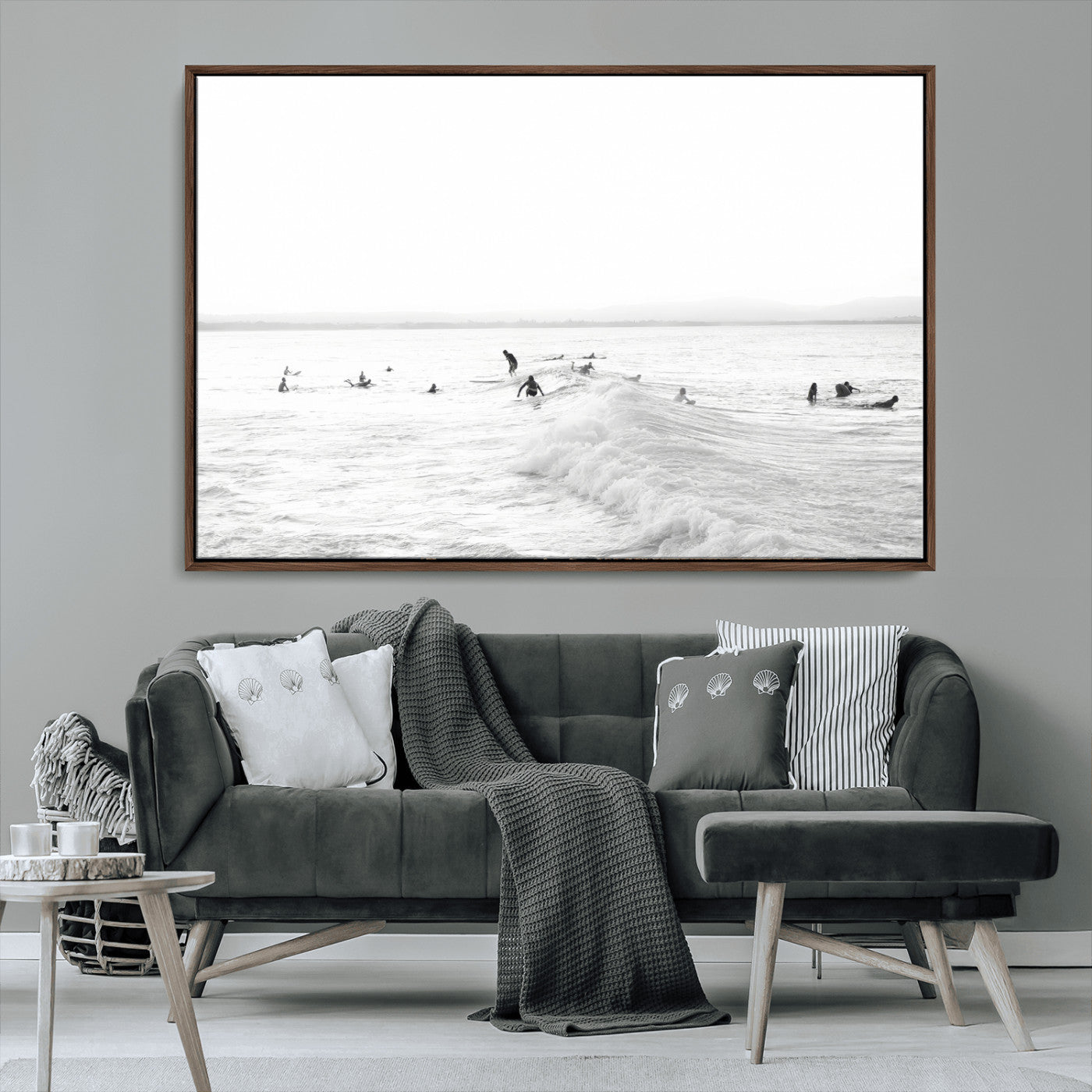 Monochrome photo of surfers riding and waiting on ocean waves, ideal for surf-themed or coastal energy wall decor.
