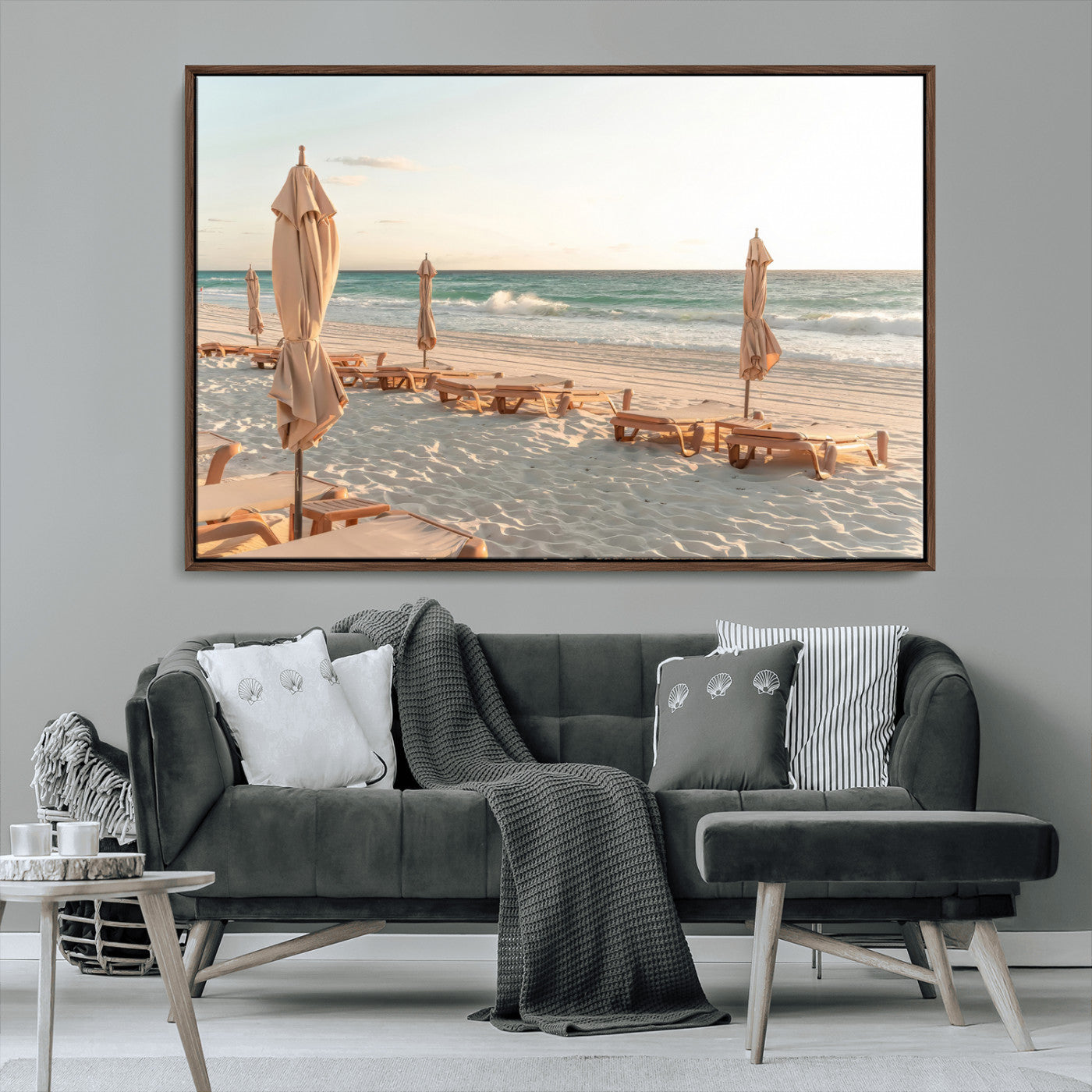 Minimalist photo of empty beach loungers and umbrellas on soft sand, ideal for calm seaside or pastel coastal-style home decor.