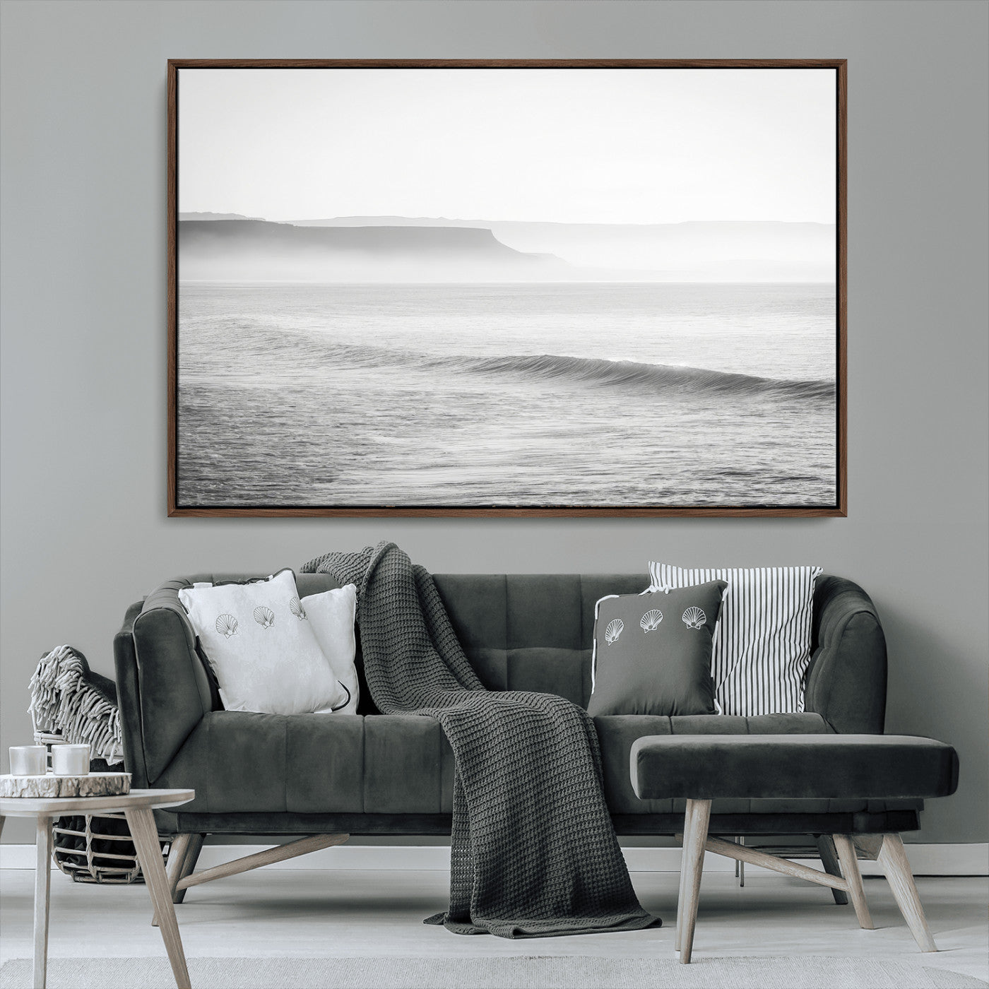 A black and white minimalist seascape featuring soft rolling waves and misty distant cliffs, creating a serene and timeless coastal atmosphere.