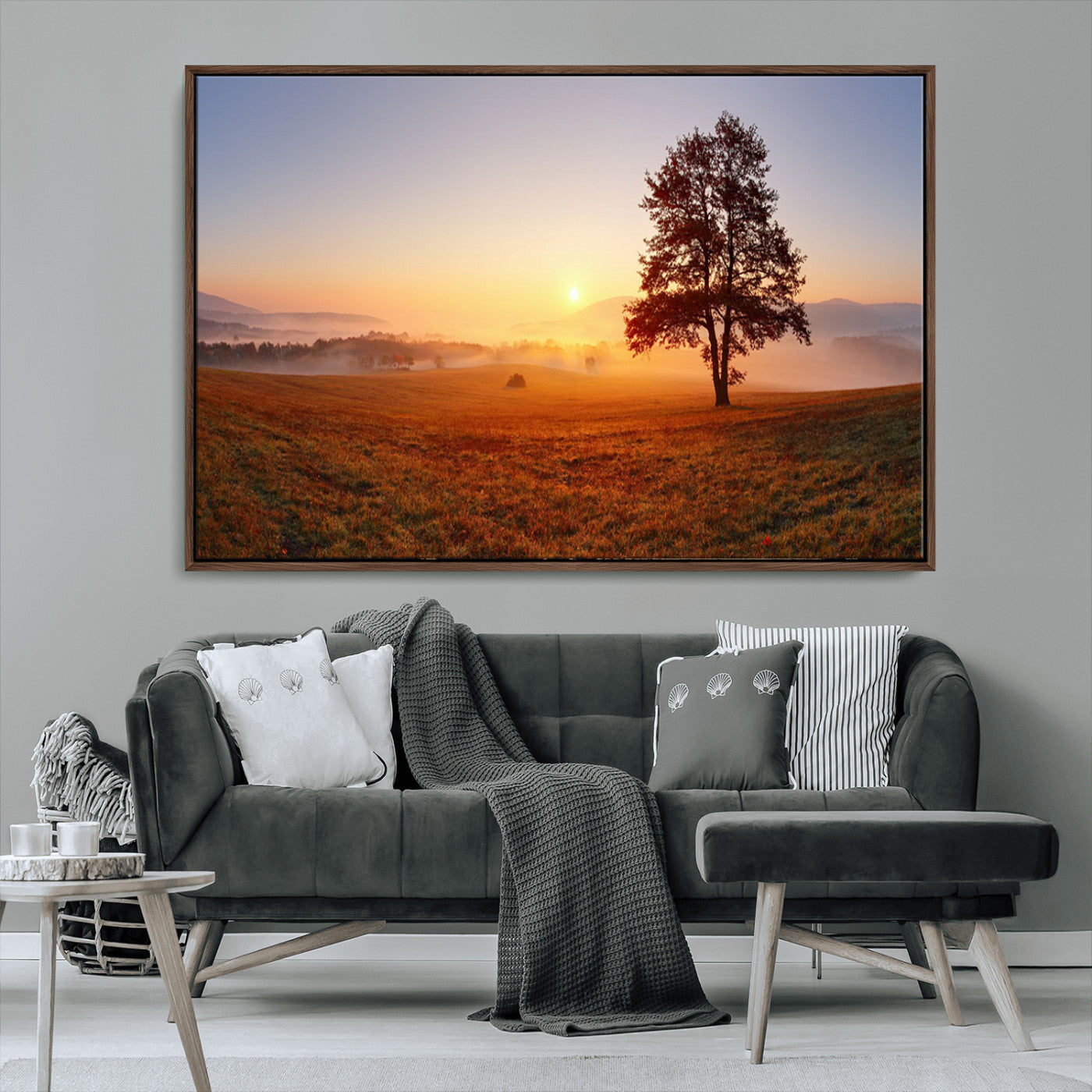 A tranquil landscape at sunrise with a mist-covered field and a lone tree, creating a peaceful and natural atmosphere.