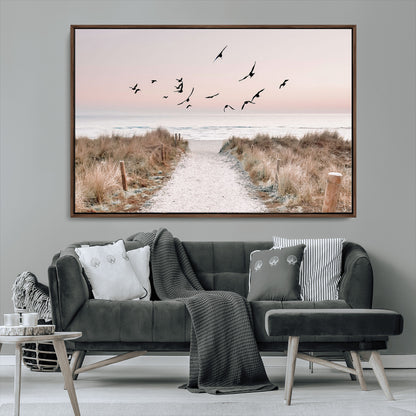 A peaceful coastal pathway leading to the ocean, with birds flying across a soft pastel sky, creating a calm and scenic beach atmosphere.