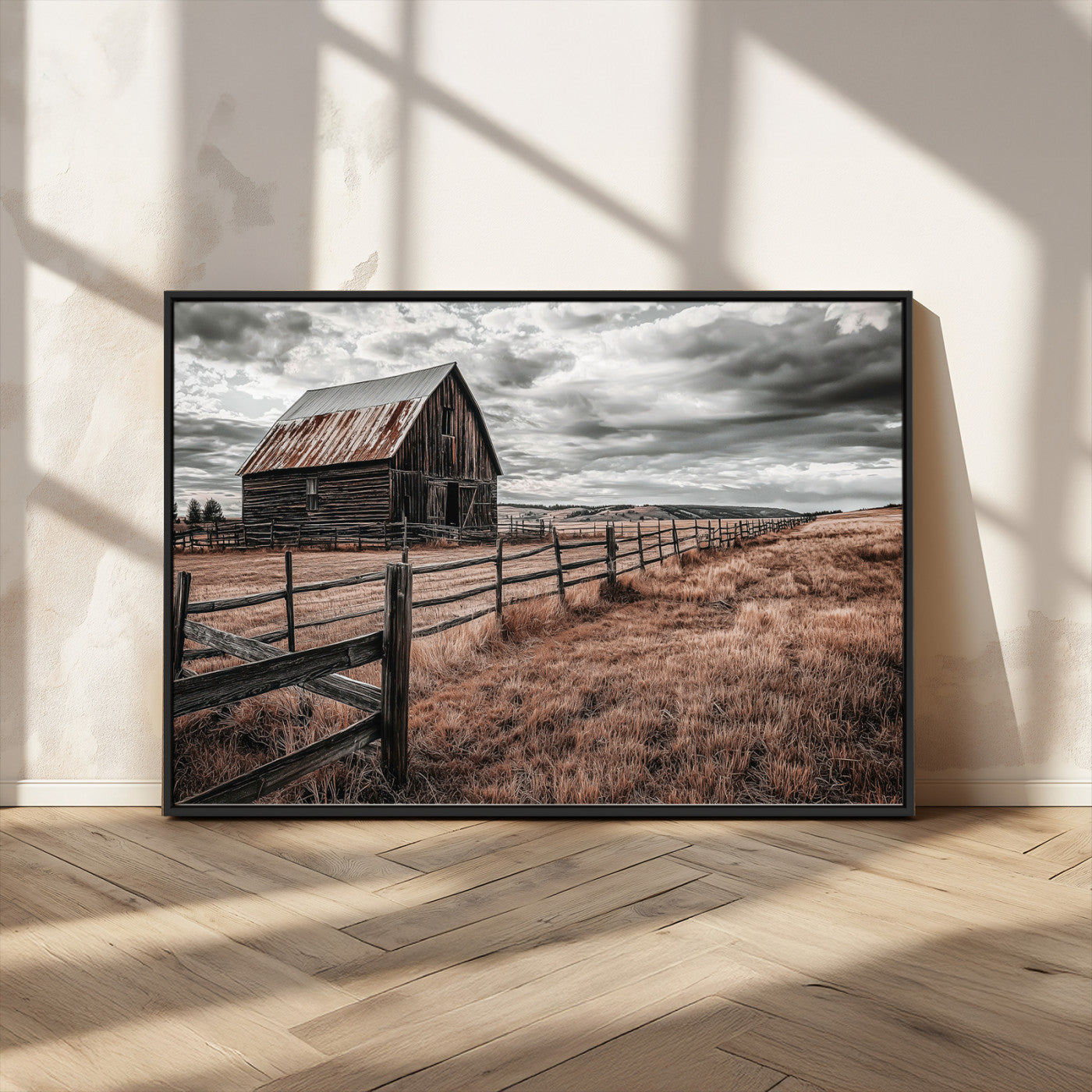 Framed canvas of a rustic barn under a moody sky with weathered fence and dark fields, ideal for farmhouse or rural-style wall decor.
