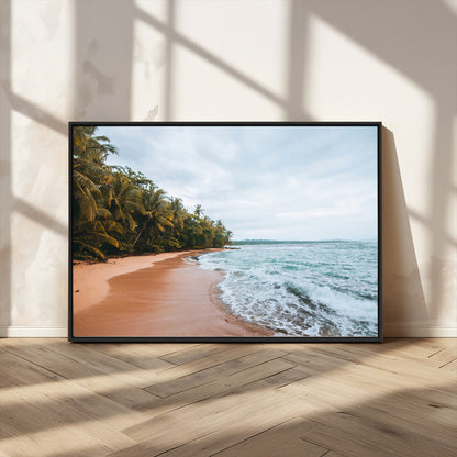 Framed canvas of a tropical beach with palm trees and soft waves, ideal for coastal escape or serene nature-inspired home decor.