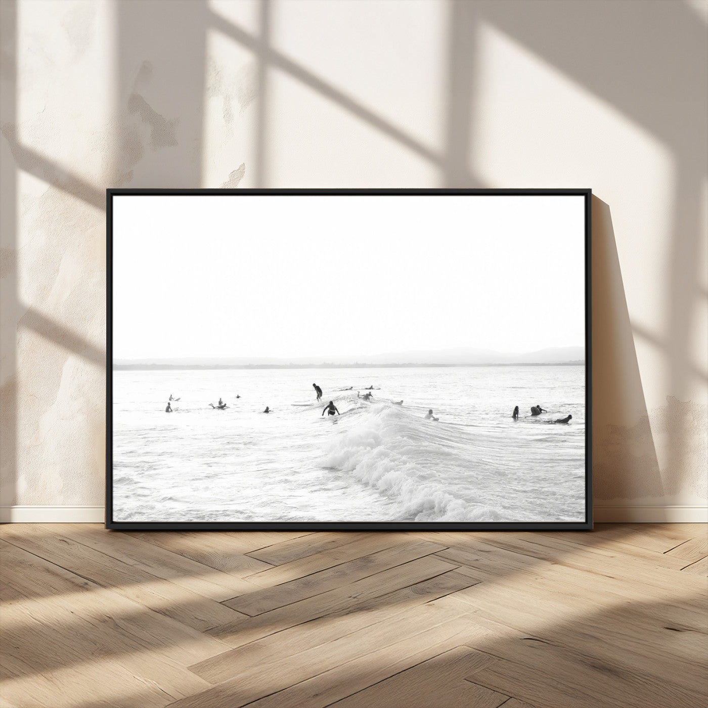 Monochrome photo of surfers riding and waiting on ocean waves, ideal for surf-themed or coastal energy wall decor.