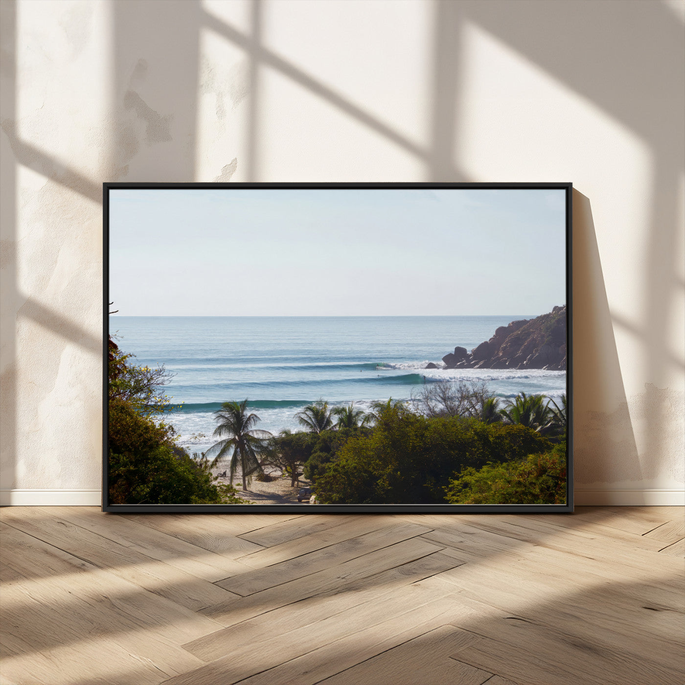 View of calm ocean waves with palm trees and a tropical coastline, ideal for coastal boho or beach-themed wall decor.