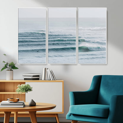 High-angle view of surfers lining up across layered ocean waves, ideal for minimal coastal or surf-inspired room decor.