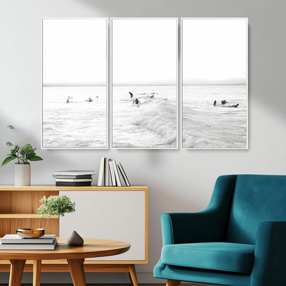 Monochrome photo of surfers riding and waiting on ocean waves, ideal for surf-themed or coastal energy wall decor.