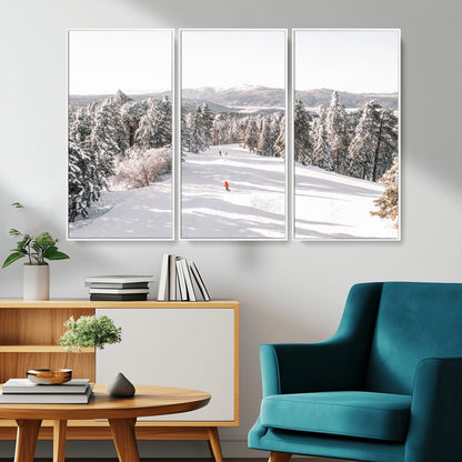Bright ski trail lined with snow-covered pines and a skier in orange, perfect for alpine adventure or winter sports-inspired decor.