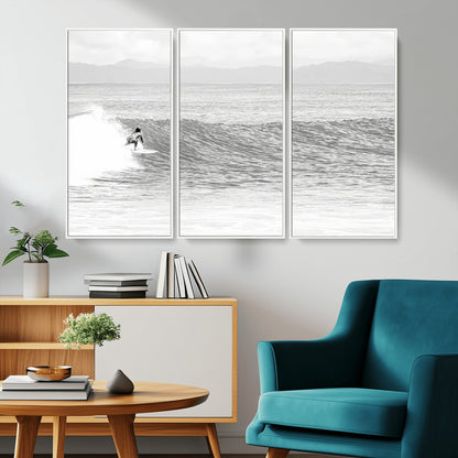 Monochrome photo of a surfer riding a wave with distant mountains, ideal for coastal motion or black and white surf-themed wall decor.