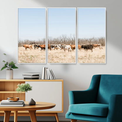 Framed wall art of Texas longhorn cattle walking through a dry, neutral-toned prairie, perfect for rustic farmhouse or western-themed home decor.