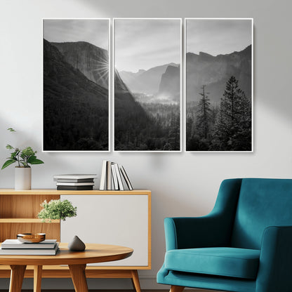 Black and white landscape of Yosemite with sun rays peeking over El Capitan, ideal for moody nature or modern rustic decor.