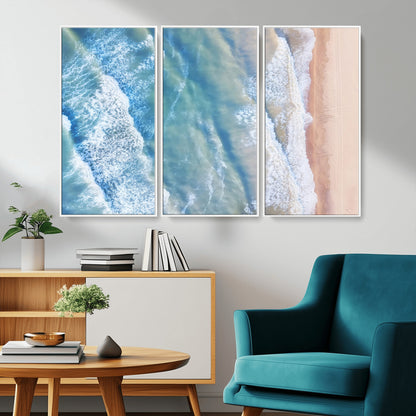 Aerial photo of soft blue waves meeting sandy shore, perfect for modern coastal or beach-themed decor with a light and tranquil aesthetic.