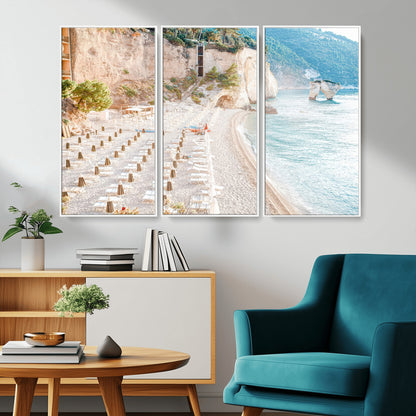 Wall art of a calm Mediterranean beach with rows of sun loungers and umbrellas in soft pastel tones, perfect for light coastal or vacation-themed decor.