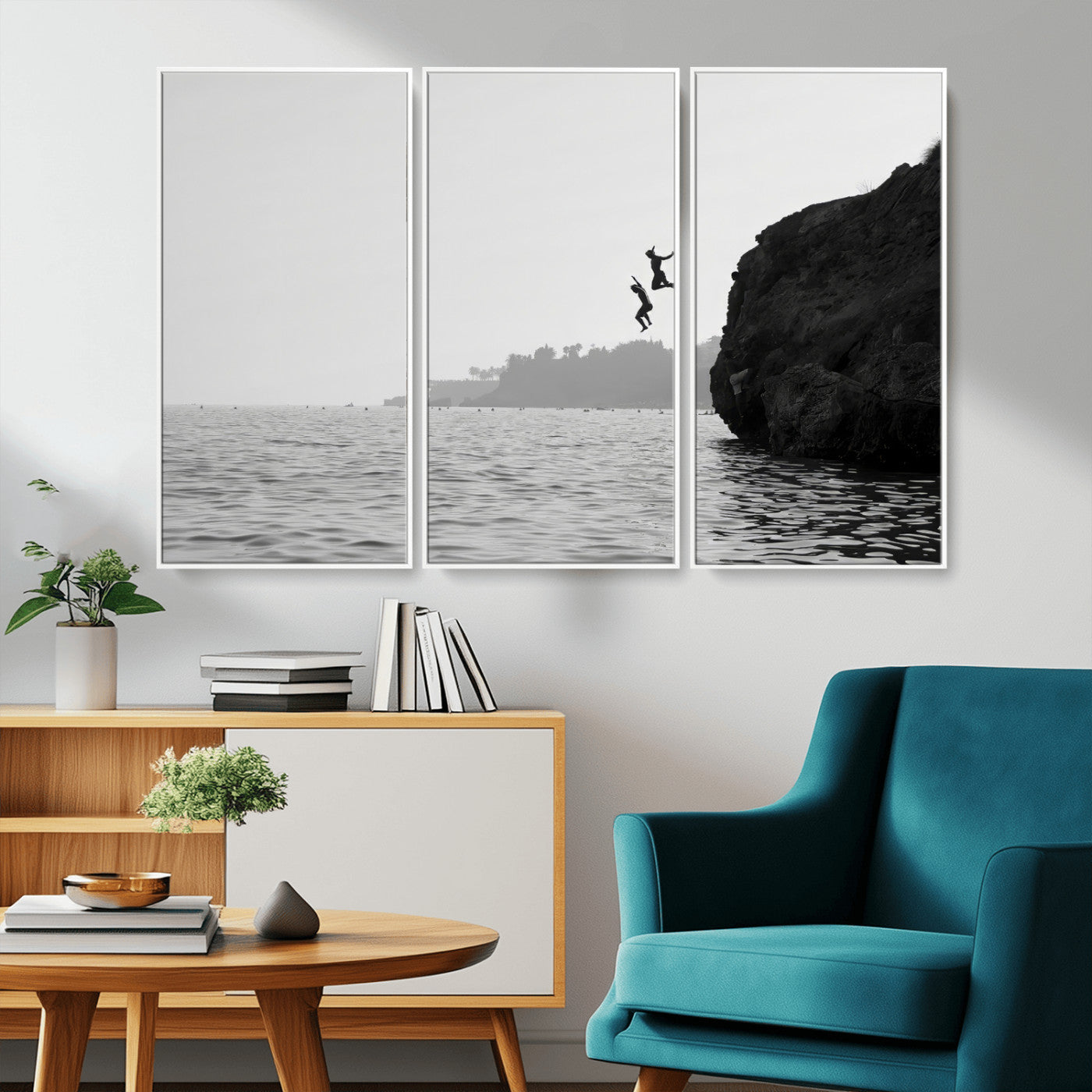 Black and white canvas of two figures cliff jumping into the sea, captured with moody tones, ideal for modern coastal or adventure-themed home decor.   2/2