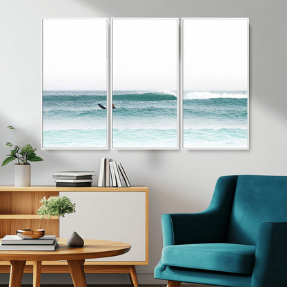 Minimalist photo of a lone surfer on calm aqua waves under bright sky, perfect for Scandinavian coastal or serene ocean-inspired home decor.