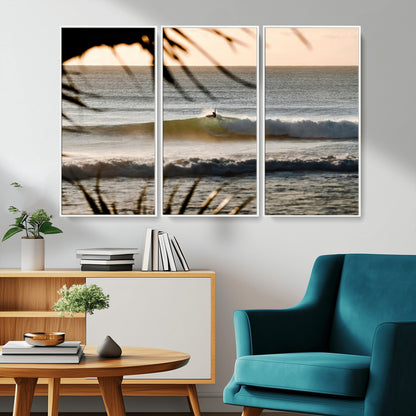 Photo of a surfer riding a golden hour wave at sunset, with tropical tones and dreamy light, perfect for tropical boho or coastal home decor.