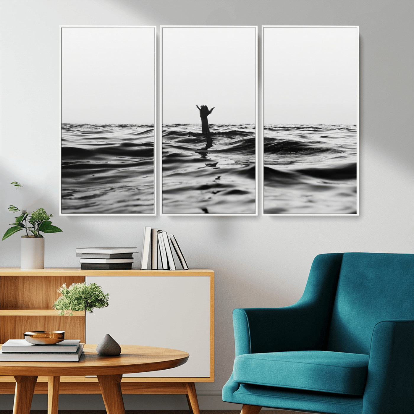 Black and white ocean with a hand making a surfer sign among dark waves, creating a dramatic and minimalist seascape with bold contrast.