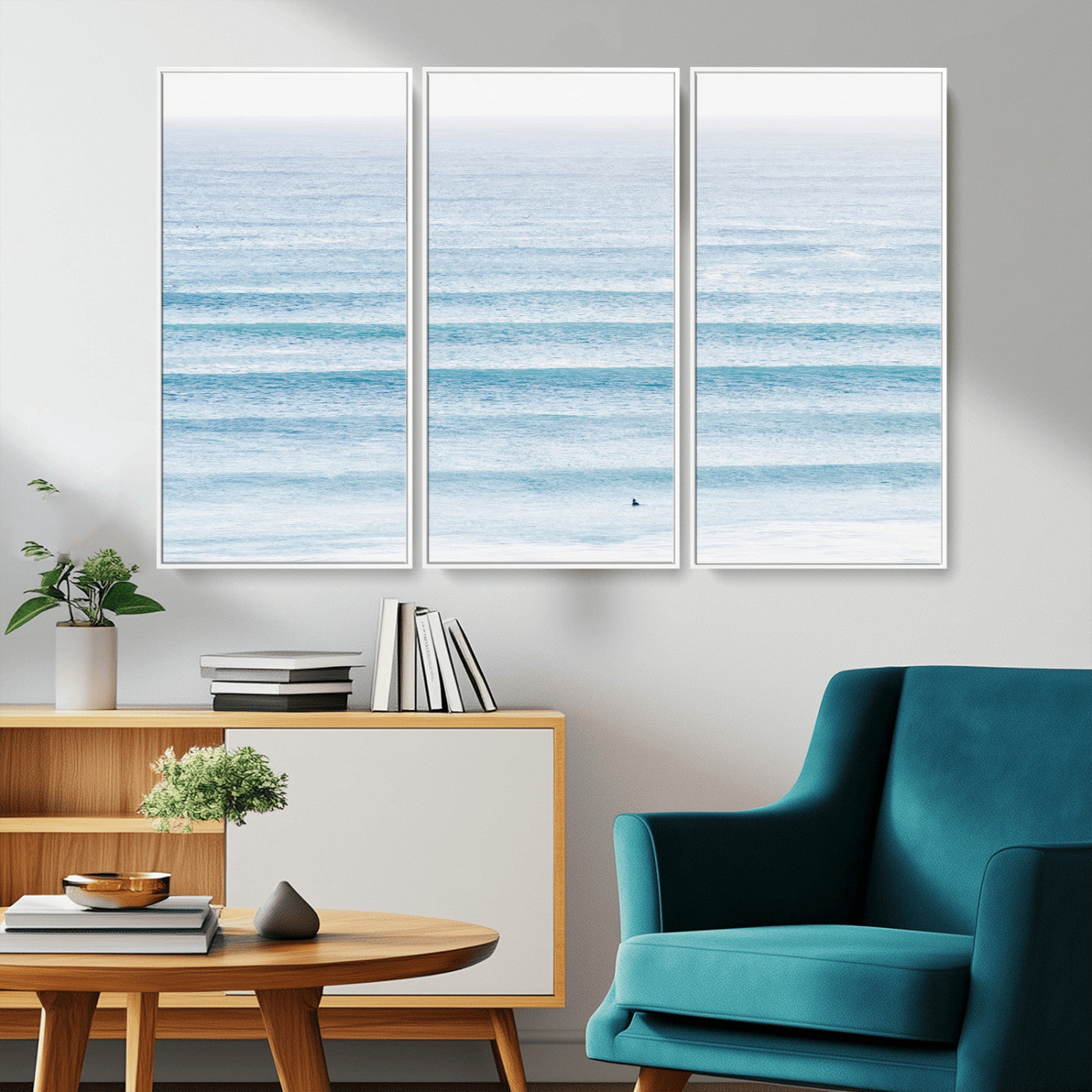 Minimalist ocean view with soft blue waves and a lone surfer, creating a serene and airy coastal aesthetic, perfect for tranquil home decor.