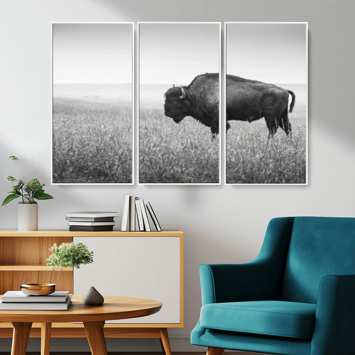 A black and white photograph of a majestic bison standing in a vast grassy prairie, evoking a sense of wilderness and strength.