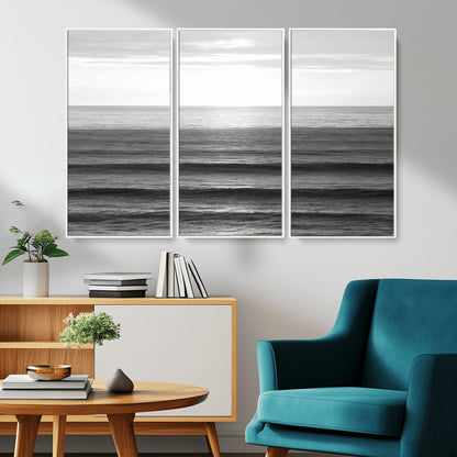 Minimalist black and white ocean view with layered waves reflecting sunlight, evoking a sense of calm and coastal serenity.