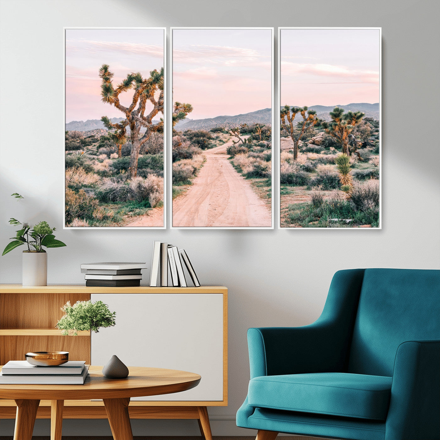 A dusty road winding through Joshua Tree National Park, framed by iconic twisted trees and warm desert tones under a soft pastel sky.