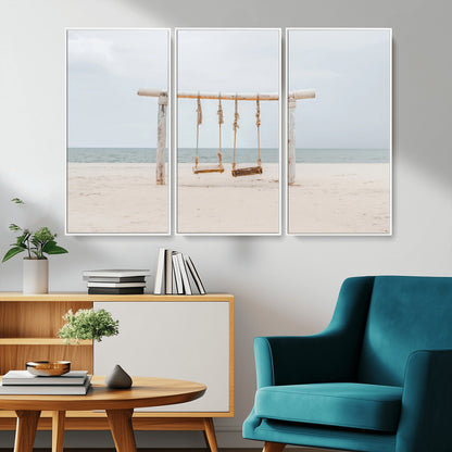 A rustic wooden beach swing stands on a serene sandy shore with an ocean horizon in the background, creating a tranquil and dreamy coastal escape.