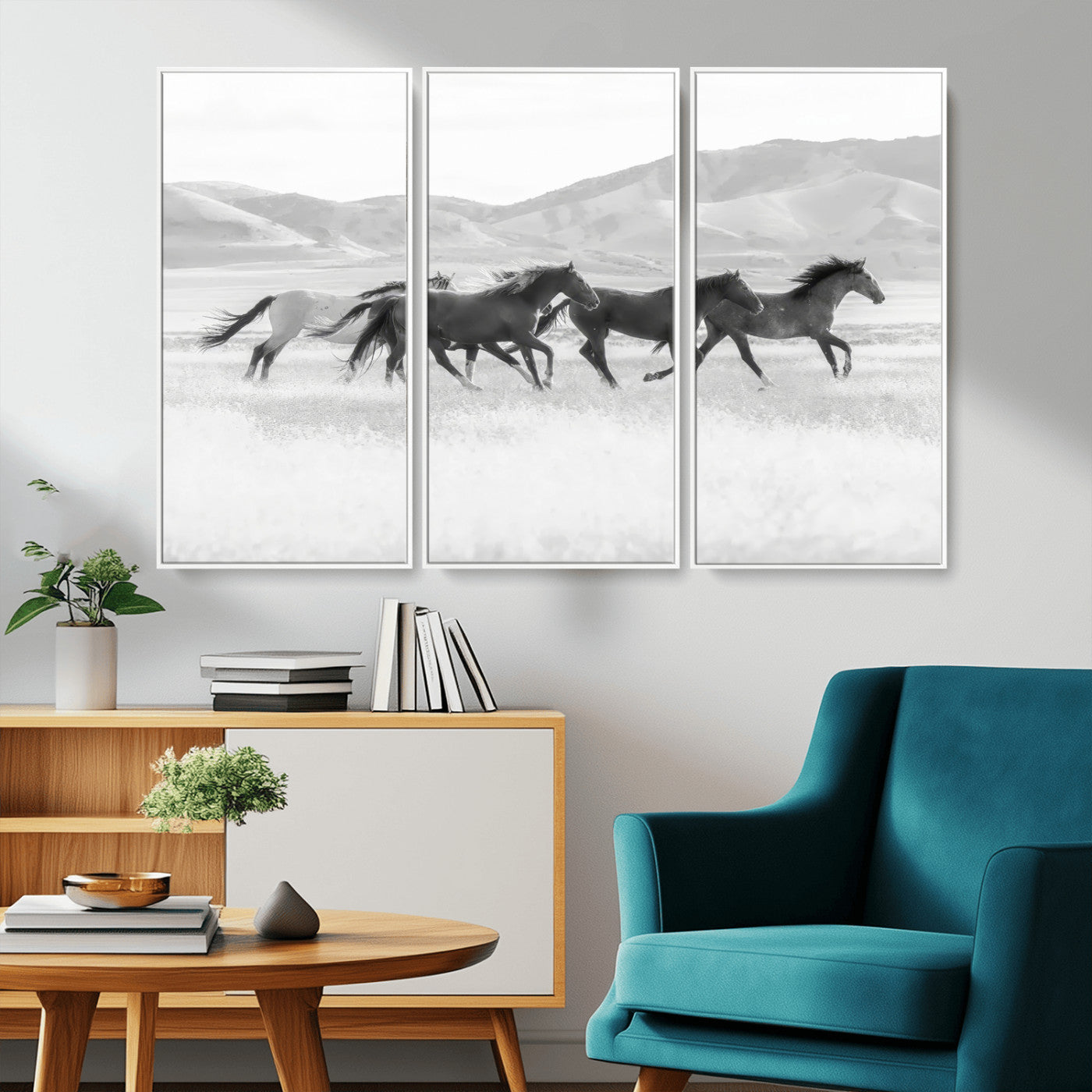 A black and white image of wild horses running freely across an open grassland, capturing the power and beauty of untamed nature in a rustic western setting.