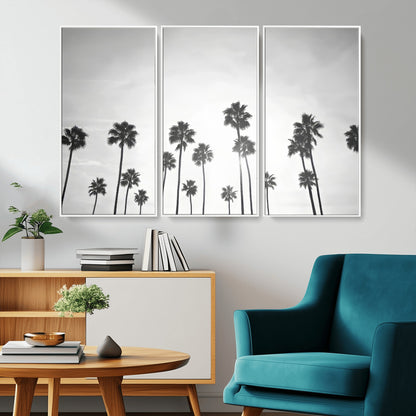 A black and white minimalist scene featuring tall palm trees silhouetted against a bright sky, creating a dreamy and timeless tropical aesthetic.
